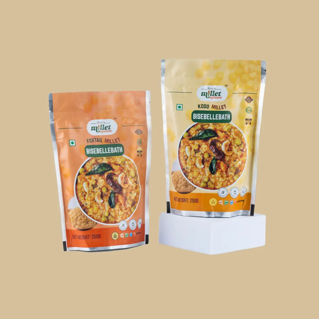 Two pouches of Foxtail Millet Bisibelebath Mix and Kodo Millet Bisibelebath Mix in 250g packaging displayed against a beige background.